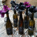 Halloween Decor on the Cheap: Pretty Poison Vases - I made these fast, easy and cheap Halloween centerpieces using old wine bottles, dollar store flowers and DIY labels made with PicMonkey.